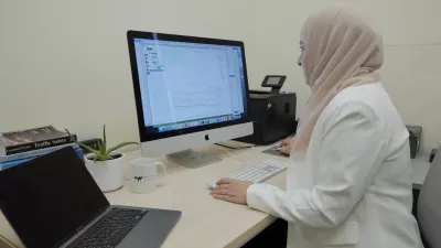 Dr. Samar al-Hajj working on the computer at her desk